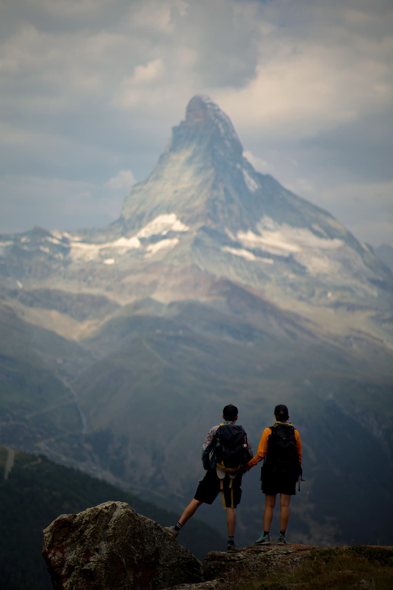 Two hikers looking at the Matterhorn